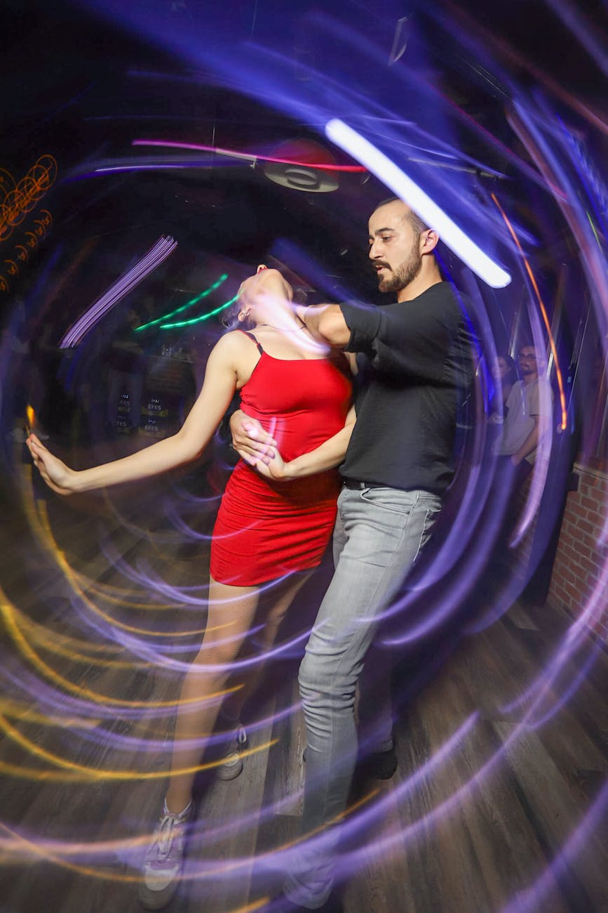 a man and woman dancing in a circular light